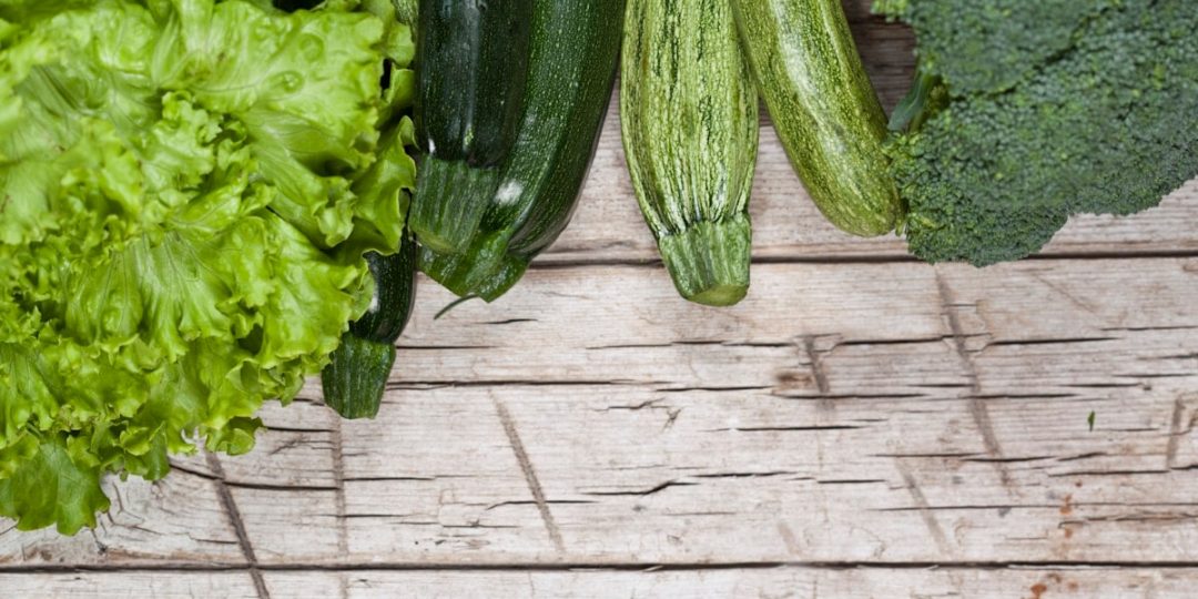 A group of vegetables sitting on top of a wooden table